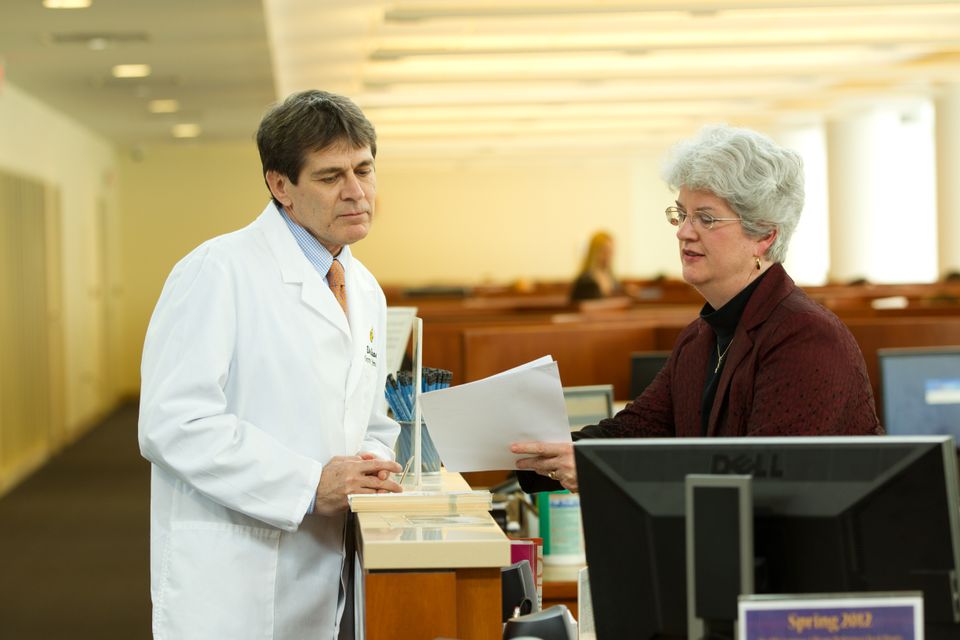 librarian consulting with doctor